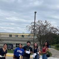 Students posing for a picture by Calder at GVSU during orientation